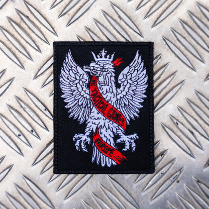 The Tactical Games Europe Eagle Patch on metal background
