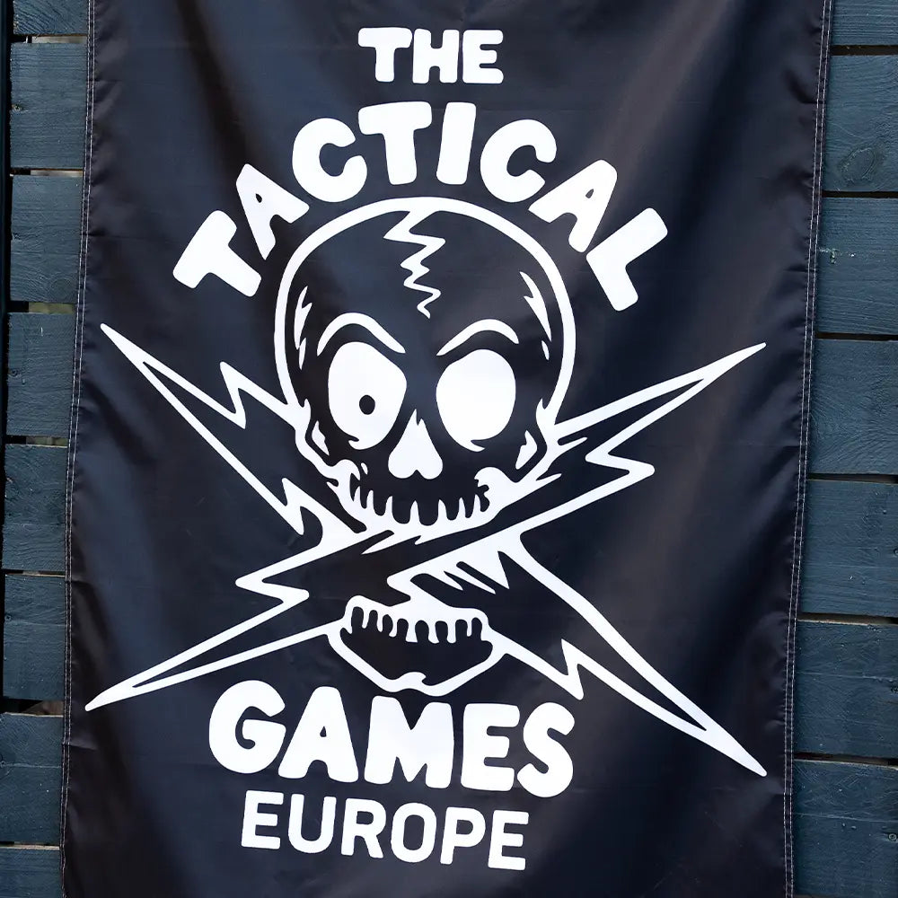 A black banner featuring a white skull and crossed lightning bolt graphic with the text 'THE TACTICAL GAMES EUROPE',
