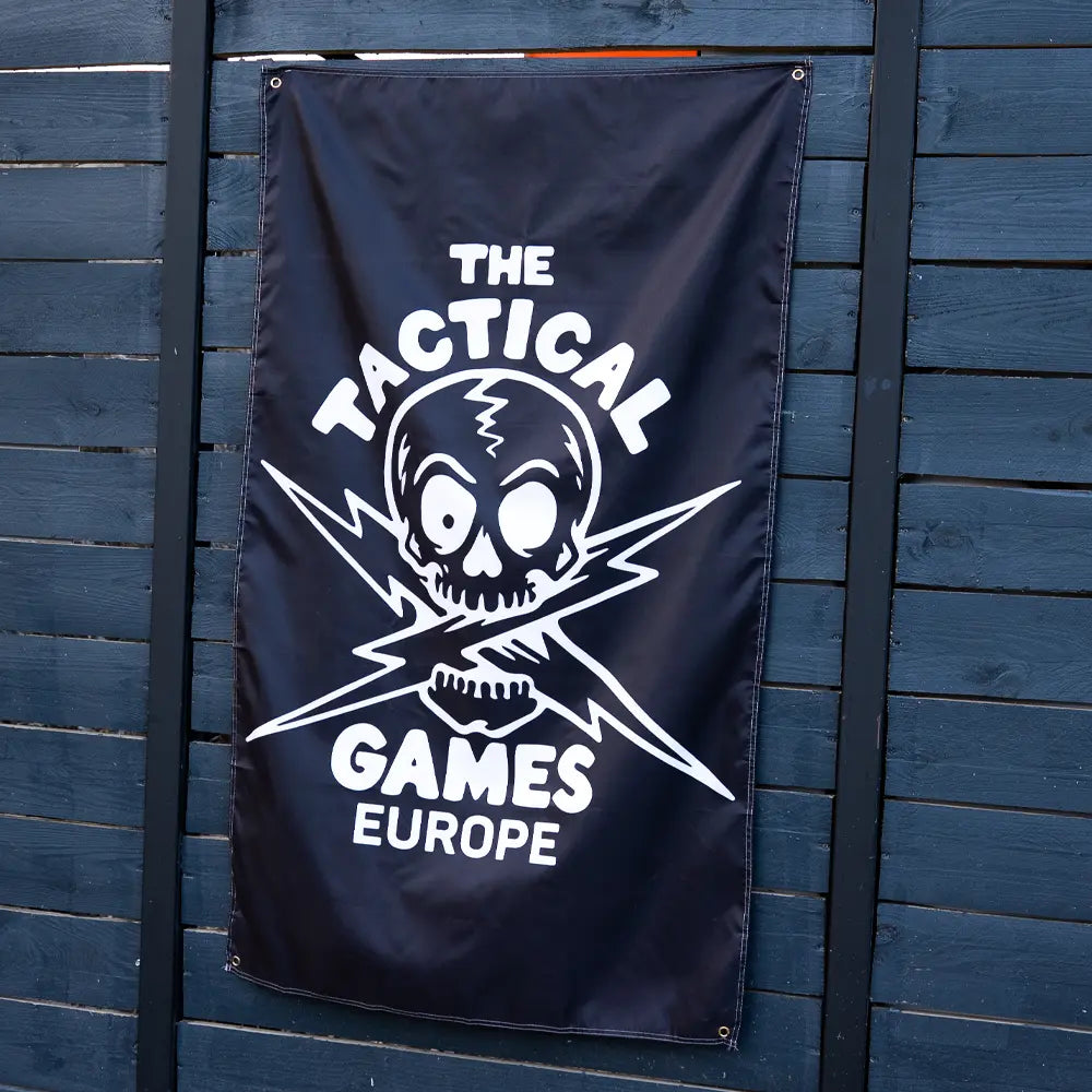 A black banner featuring a white skull and crossed lightning bolt graphic with the text 'THE TACTICAL GAMES EUROPE',
