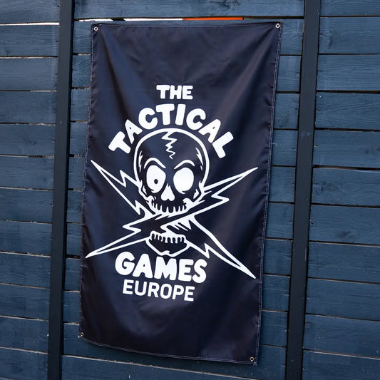 A black banner featuring a white skull and crossed lightning bolt graphic with the text 'THE TACTICAL GAMES EUROPE',
